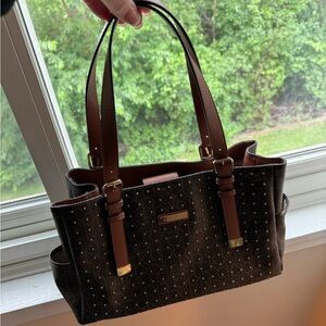 Calvin Klein purse with brass stud detailing on front, CK logo, shoulder straps